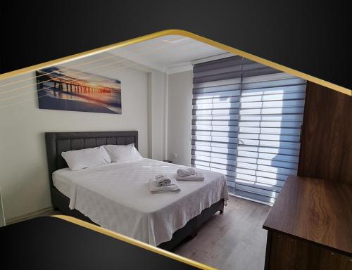 a bedroom with a bed and a large window at GRAND ÇAYKARAM HOTEL in Çaykara