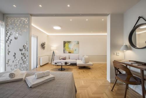 a living room with a bed and a couch at Chic central Athens apartment at Mavilli Sq. in Athens