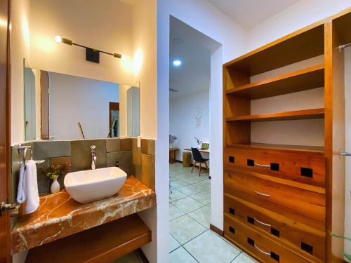 a bathroom with a sink and a mirror at Humant Coliving - Cancún in Cancún