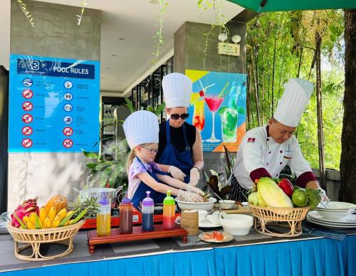 a group of people in chefsuits preparing food on a table at Bayon Modern Residence in Siem Reap