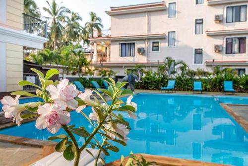 a villa with a swimming pool in front of a building at Luxurious Villa with Private Swimming Pool, Kids Pool, Games, Private Parking in Calangute