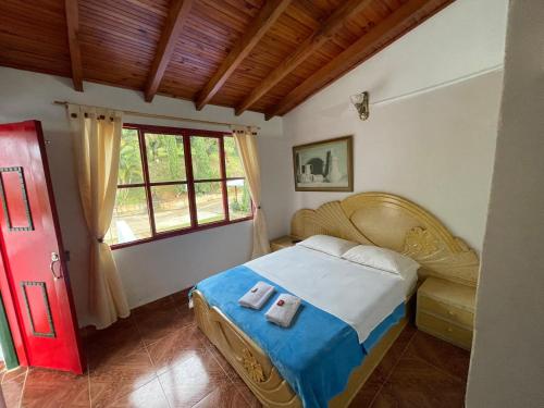 a bedroom with a bed with two towels on it at El Gran Mirador in Buenavista