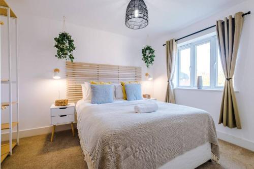 Luxurious Cosy 4BR Home Cheshire في Saughall: غرفة نوم بيضاء مع سرير كبير ونافذة