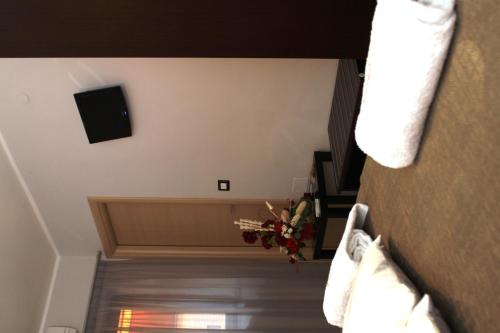 a room with a couch and a television on the wall at B&B Tra Monti e Mare in Ogliastro Cilento
