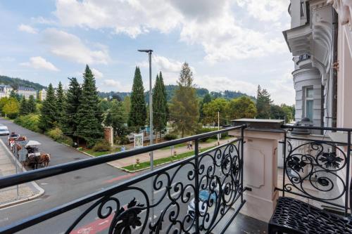 a balcony with a view of a street and trees at OREA Spa Hotel Palace Zvon Mariánské Lázně in Mariánské Lázně