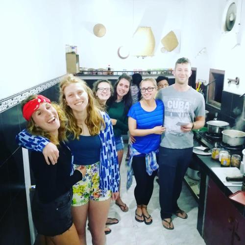 a group of people standing in a kitchen at Rock View Hostel Ella in Ella