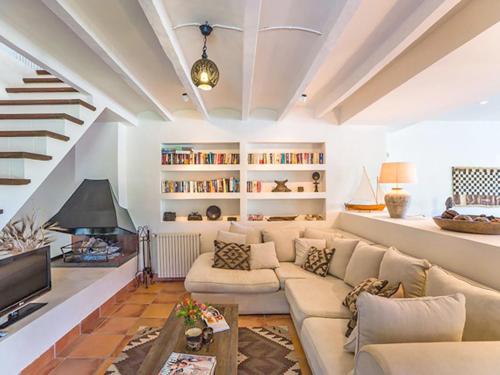 uma sala de estar com um sofá e uma televisão em Cas Puput em Sóller