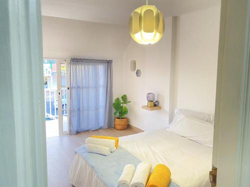 a bedroom with a bed with towels on it at HomeForGuest Two bedroom Apartment with pool and terrace in Caleta De Fuste