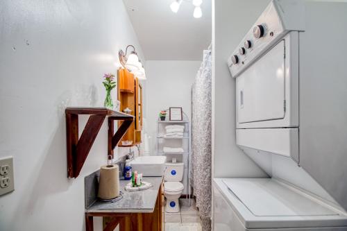 a small bathroom with a sink and a refrigerator at Mattea Vacation House at Bella Vue Estate in Georgeville