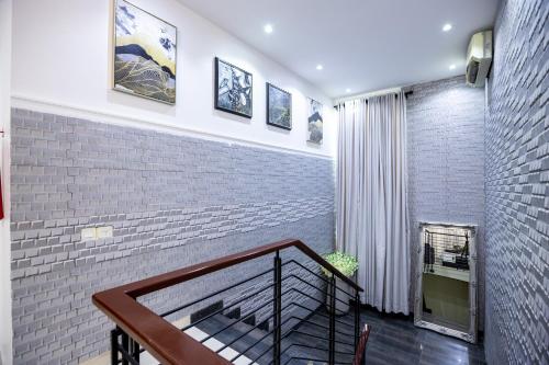 a staircase in a house with a brick wall at Rushmore - Standard Room in Lagos
