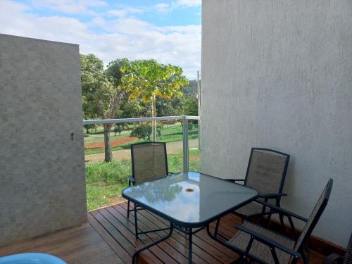 a patio with a glass table and chairs on a balcony at Casa Capitolio in Capitólio