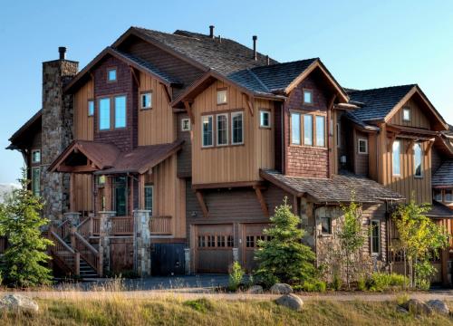 a large wooden house with a gambrel at The Porches in Steamboat Springs