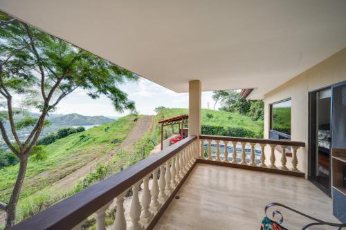 a balcony with a view of a hillside at Casa Gerónimo in Playa Hermosa