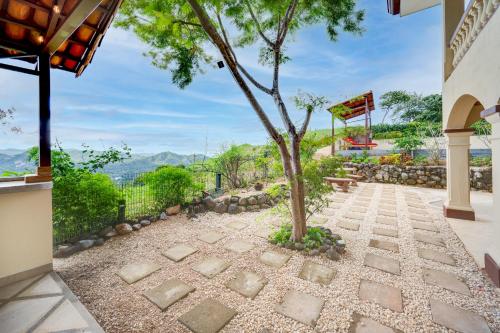 a tree in the middle of a walkway at Casa Gerónimo in Playa Hermosa