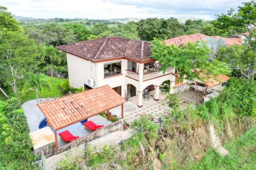 an aerial view of a house with red chairs at Casa Gerónimo in Playa Hermosa