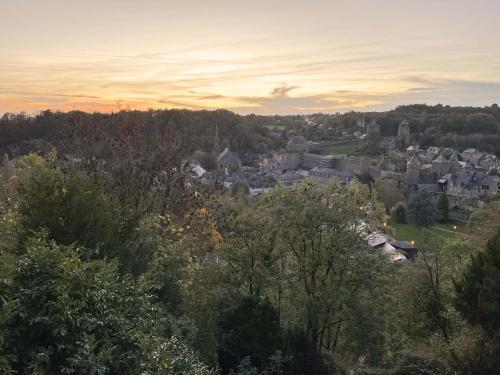 a view of a town with trees and buildings at Mercier de Montigny - Les Chambres du Beffroi - SPA et Massage in Fougères