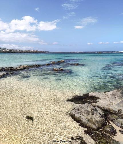 a beach with rocks and the water at Villa Kazabona Saint-Pierre centre - Chambres d'hôte in Saint-Pierre