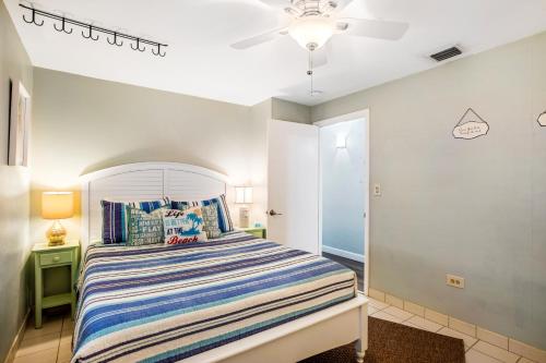 a bedroom with a bed and a ceiling fan at Sea Salt Harbor in Marathon