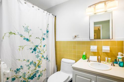 a bathroom with a toilet and a shower curtain at Sea Salt Harbor in Marathon