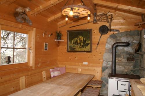 a dining room in a log cabin with a wooden table at Vordergugg in Mittersill