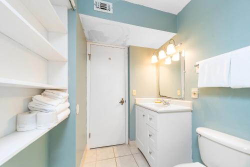 a bathroom with a white toilet and a sink at Summit Beach Resort 1412 in Panama City Beach