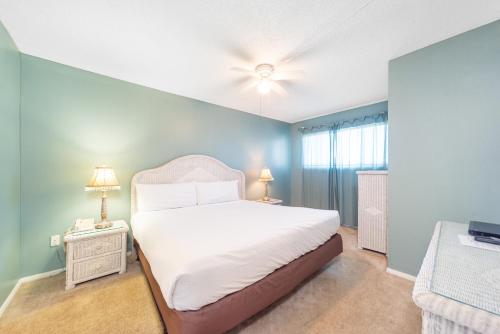 a bedroom with a bed and a ceiling fan at Summit Beach Resort 1412 in Panama City Beach