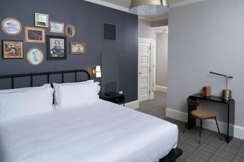 a bedroom with a large white bed and a desk at Copley Square Hotel in Boston