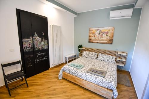 a bedroom with a bed and a painting on the wall at Dream House in Piazza Armerina