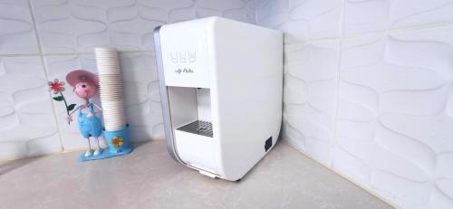 a white appliance sitting on the floor next to a wall at Mina Akko sea view in ‘Akko