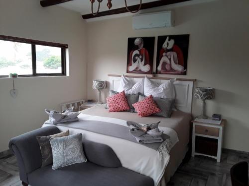 a bedroom with a large bed and a couch at Monas Risibiki Westside in Kleinmond