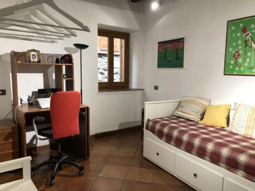 a bedroom with a bed and a desk with a computer at Verso Sud in Sutri