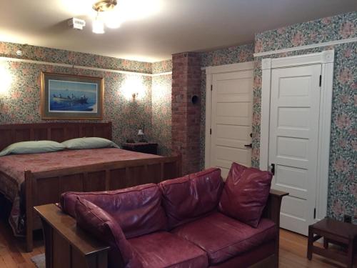 a living room with a bed and a couch at Alaska's Capital Inn Bed and Breakfast in Juneau
