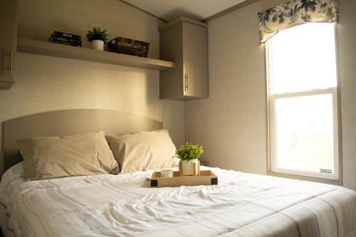 a bedroom with a large white bed with a window at Vine Ridge Resort in Niagara on the Lake