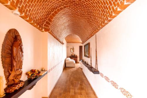 a hallway with a brick ceiling and a long hallway at Hacienda Maria Eugenio in Guanajuato