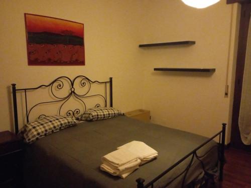 a bedroom with a bed with two towels on it at Niguarda Alfred House in Bresso