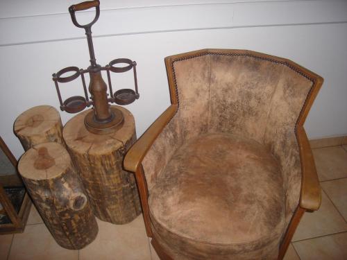 a wooden chair with a lamp and some logs at Amymone and Adiandi in Nafplio