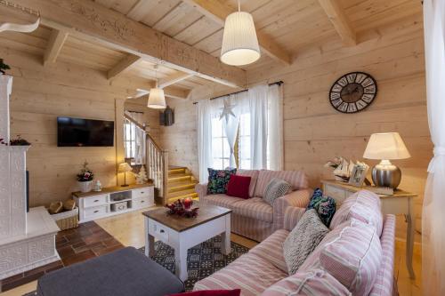 a living room with a couch and a table at Osada Maruszyna in Szaflary