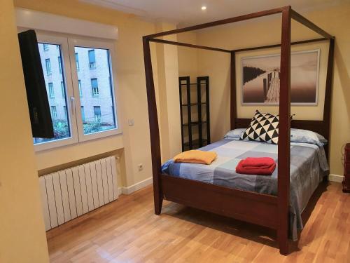 a bedroom with a canopy bed with two towels on it at LUXURY HOUSE-HERMOSA VIVIENDA LUJO-APPART DE LUXE in Madrid