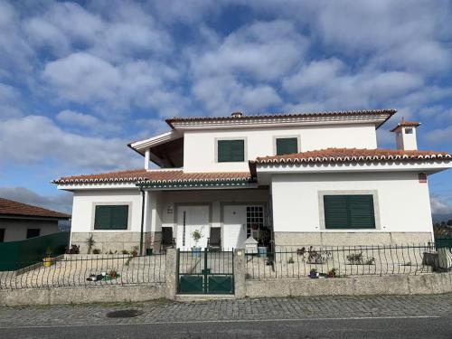 a white house with a fence in front of it at Centro da cidade Amarante in Amarante