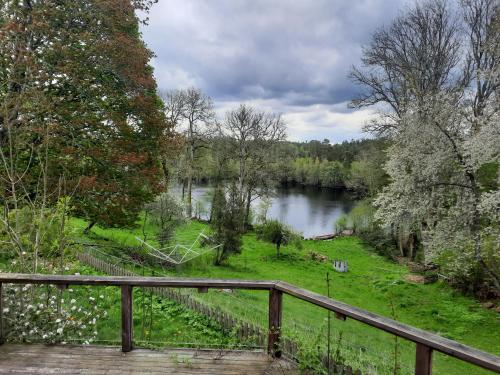 a view of a river from a wooden bridge at Sjötorps Säteris Bed & Breakfast Flygeln in Larv