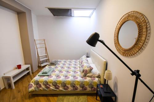 a bedroom with a bed with a lamp and a mirror at Dream House in Piazza Armerina