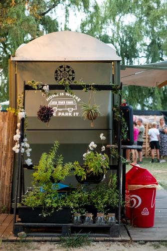 a gazebo with potted plants on it at Camping Eden Glamping in Dormelletto
