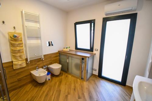 a bathroom with a tub and a toilet and a sink at Dream House in Piazza Armerina