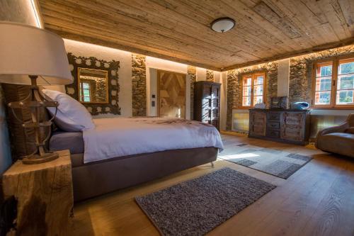 a bedroom with a bed in a room with wooden ceilings at Mratschnigger Hof in Keutschach am See