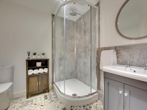 a bathroom with a shower and a toilet and a sink at Heron Apartment in Berwick-Upon-Tweed