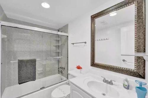 a bathroom with a tub and a sink and a mirror at Amazing Apartment on hollywood beach TIDES in Hollywood