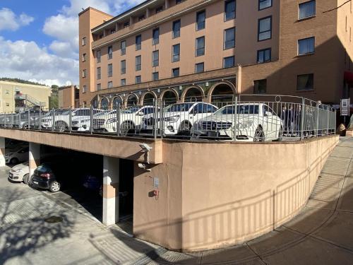 a group of cars parked on a bridge in front of a building at Hotel Giò Wine e Jazz Area in Perugia