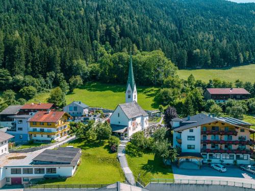 an aerial view of a small village with a church at Central Hotel & Apart mit Landhaus Central in Fügen