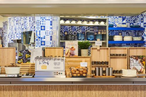 a store counter with blue and white ceramics at ibis Paris La Villette Cité des Sciences 19ème in Paris