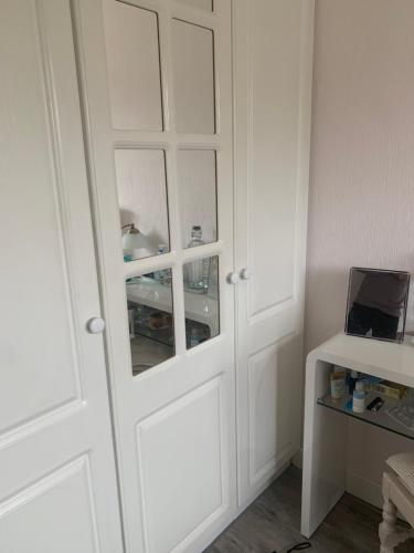 a white cabinet with a door in a room at 97 Granville road in Dublin